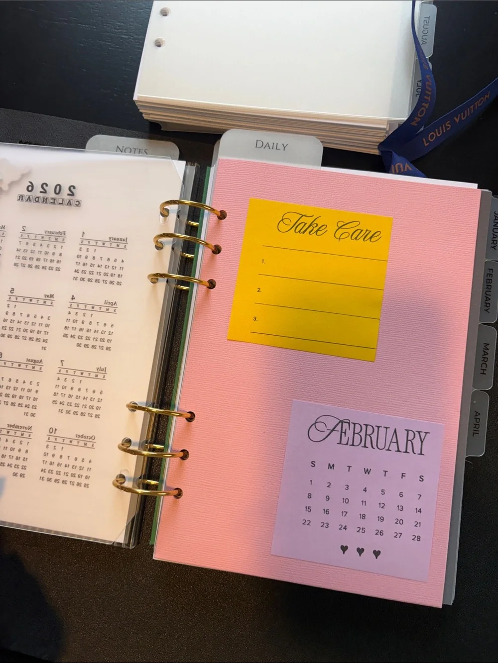 A5 Planner Pages with Blue Ribbon and Gold Rings.
